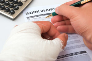 Palm Beach Gardens Workers Comp Lawyer- injured person filling out document